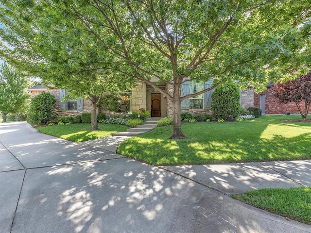 4109 Riva Ridge Ct, Edmond, OK 73003 - view of property hidden behind natural elements featuring a front yard and stone siding
