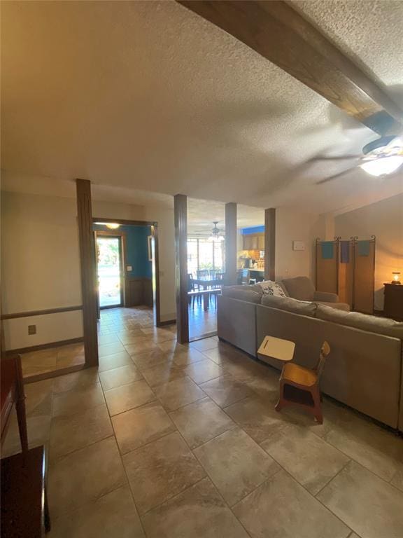 513 9th Street Cir, Hydro, OK 73048 - living area featuring a textured ceiling, ceiling fan, healthy amount of natural light, and light tile patterned floors