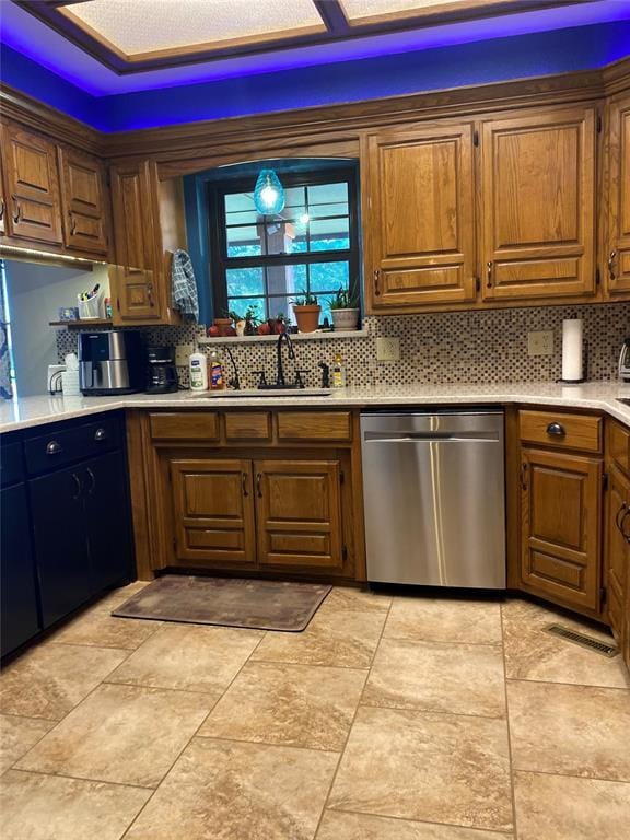 513 9th Street Cir, Hydro, OK 73048 - kitchen with stainless steel dishwasher, backsplash, light countertops, and brown cabinets