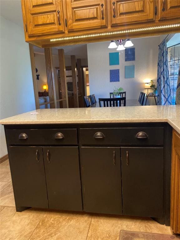 513 9th Street Cir, Hydro, OK 73048 - kitchen featuring light tile patterned flooring and brown cabinetry
