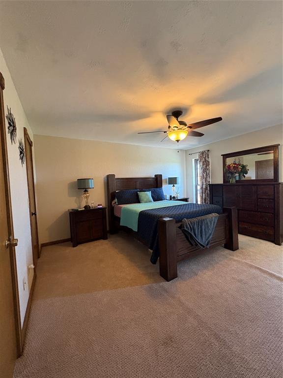 513 9th Street Cir, Hydro, OK 73048 - bedroom with light colored carpet and a ceiling fan