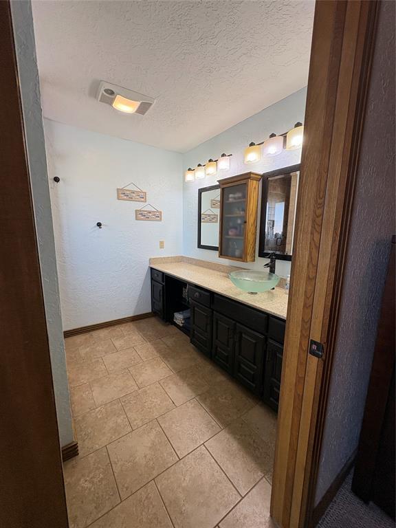 513 9th Street Cir, Hydro, OK 73048 - bathroom featuring vanity and a textured ceiling