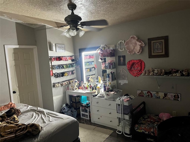 bedroom with a textured ceiling and ceiling fan