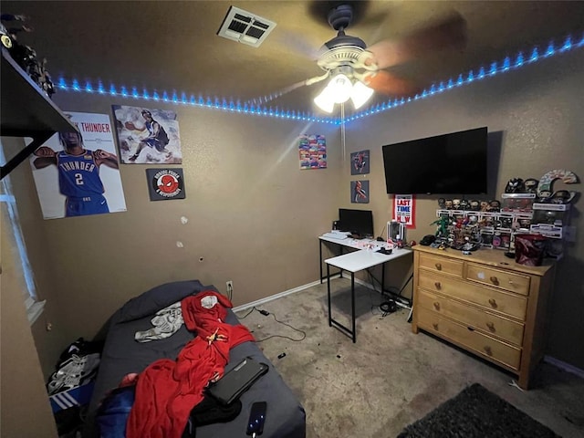 carpeted bedroom featuring an office area