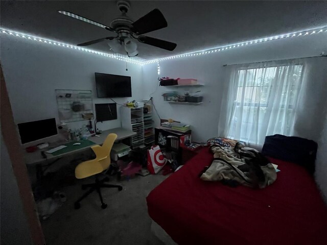 bedroom featuring an office area and carpet flooring