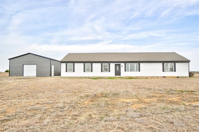 1646 County Road 1245, Tuttle, OK 73089 - view of front of home with a garage, an outbuilding, and roof with shingles