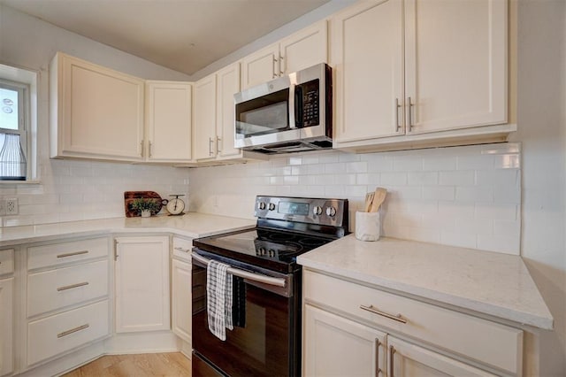 1646 County Road 1245, Tuttle, OK 73089 - kitchen with stainless steel appliances, decorative backsplash, light stone counters, and light wood-style flooring
