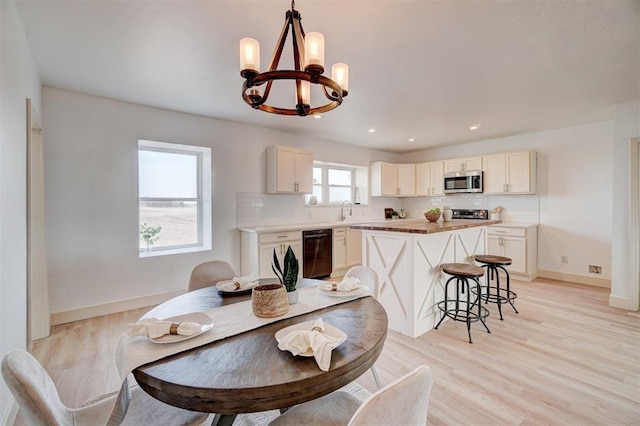 1646 County Road 1245, Tuttle, OK 73089 - dining space with a chandelier, light wood-type flooring, and recessed lighting