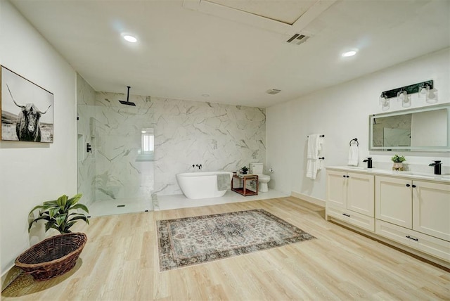 1646 County Road 1245, Tuttle, OK 73089 - bathroom with a marble finish shower, double vanity, a soaking tub, wood finished floors, and recessed lighting