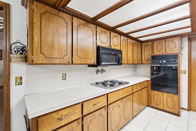 410 E Johnson St, Lexington, OK 73051 - kitchen featuring a warming drawer, black appliances, and brown cabinetry
