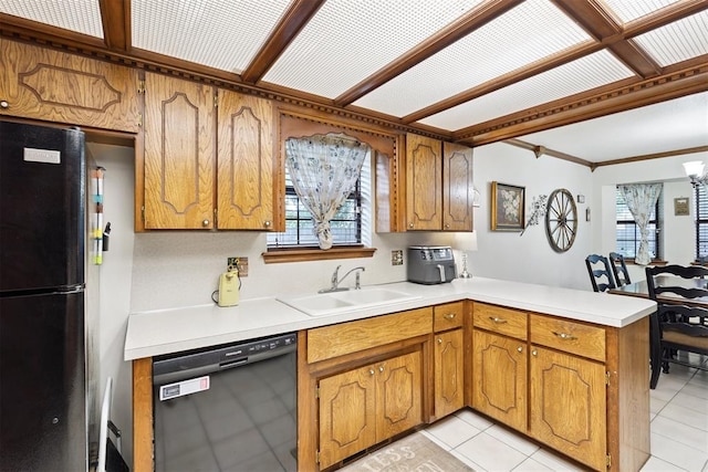 410 E Johnson St, Lexington, OK 73051 - kitchen featuring black appliances, a peninsula, brown cabinetry, light countertops, and ornamental molding