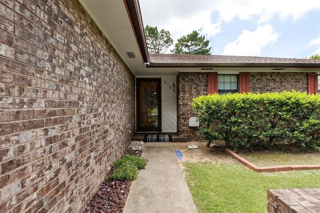 410 E Johnson St, Lexington, OK 73051 - doorway to property featuring brick siding and a lawn