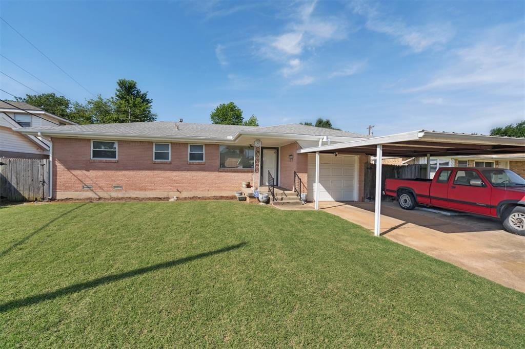 856 N Windermere Dr, Moore, OK 73160 - ranch-style home with an attached garage, brick siding, crawl space, driveway, and an attached carport