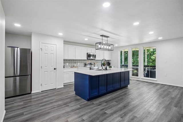 1600 Silver Stone Rd, Blanchard, OK 73010 - kitchen with stainless steel appliances, white cabinets, recessed lighting, dark wood finished floors, and light countertops