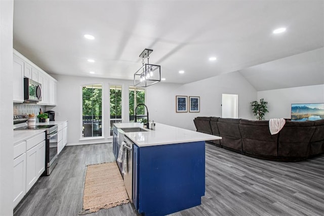 1600 Silver Stone Rd, Blanchard, OK 73010 - kitchen featuring appliances with stainless steel finishes, wood finished floors, white cabinets, recessed lighting, and light countertops