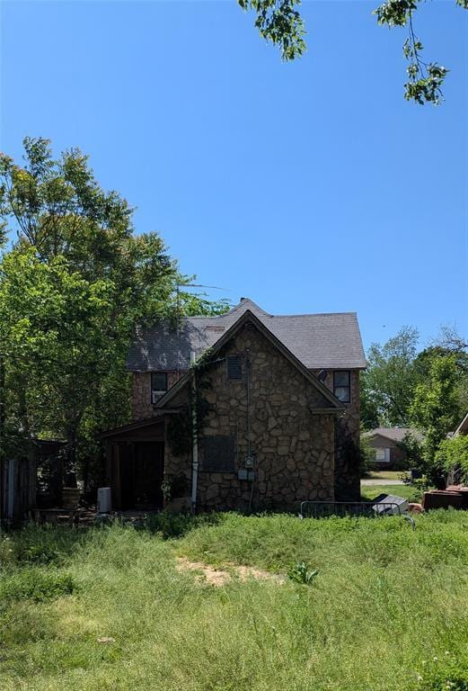 121 N High Ave, Shawnee, OK 74801 - view of side of home featuring stone siding