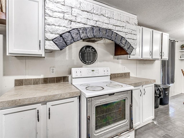 106411 Happy Trails Rd, Mcloud, OK 74851 - kitchen with white range with electric stovetop, white cabinets, light countertops, and a textured ceiling