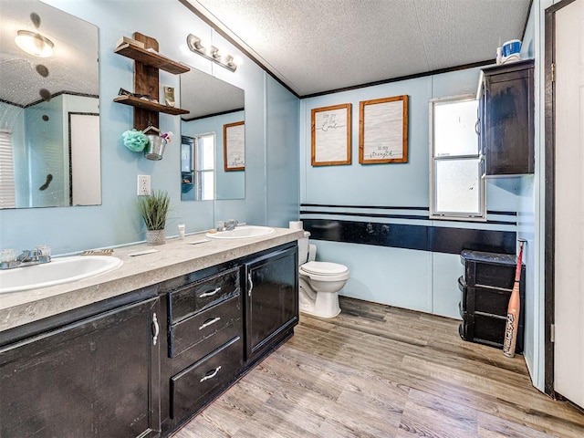 106411 Happy Trails Rd, Mcloud, OK 74851 - full bathroom with double vanity, a textured ceiling, and wood finished floors