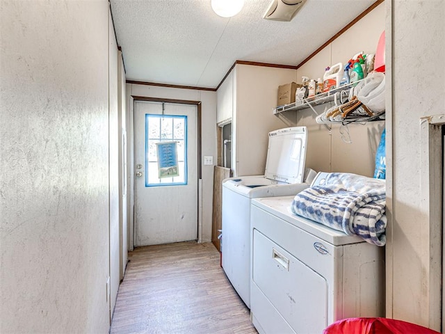 106411 Happy Trails Rd, Mcloud, OK 74851 - laundry area featuring washing machine and clothes dryer, light wood-style flooring, a textured ceiling, and ornamental molding