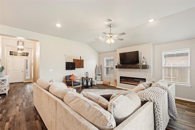 8705 Gibbs Dr, Oklahoma City, OK 73135 - living area featuring dark wood-type flooring, vaulted ceiling, ceiling fan, a glass covered fireplace, and recessed lighting