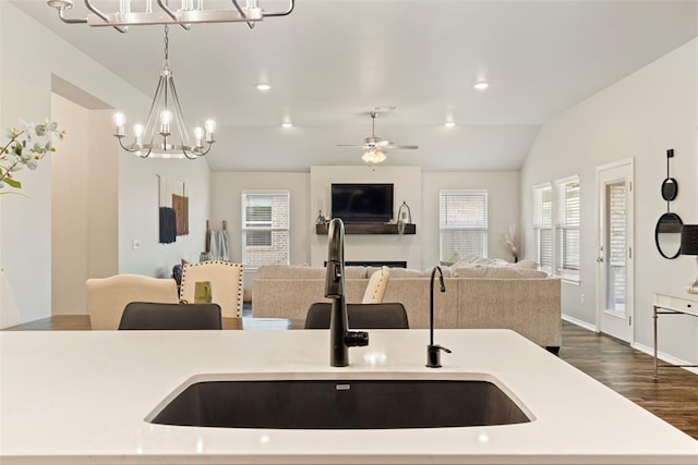 8705 Gibbs Dr, Oklahoma City, OK 73135 - kitchen featuring a chandelier, open floor plan, dark wood finished floors, hanging light fixtures, and a center island with sink