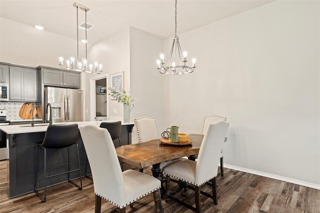 8705 Gibbs Dr, Oklahoma City, OK 73135 - dining space with a chandelier and dark wood-style flooring