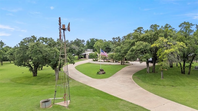 2800 E 15th St, Edmond, OK 73013 - view of property's community with a yard, view of wooded area, and curved driveway