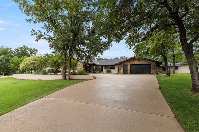 2800 E 15th St, Edmond, OK 73013 - ranch-style house featuring a garage, concrete driveway, a front yard, and stone siding