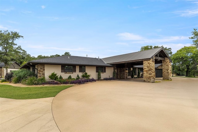 2800 E 15th St, Edmond, OK 73013 - view of front of property with stone siding, driveway, stucco siding, and a carport