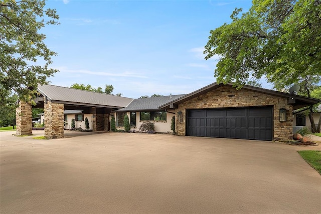 2800 E 15th St, Edmond, OK 73013 - view of front of house featuring stone siding, driveway, and a garage