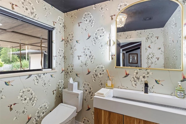 2800 E 15th St, Edmond, OK 73013 - bathroom featuring wallpapered walls and vanity