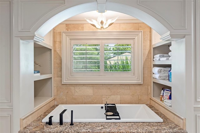 2800 E 15th St, Edmond, OK 73013 - bathroom with a garden tub, a chandelier, and built in shelves