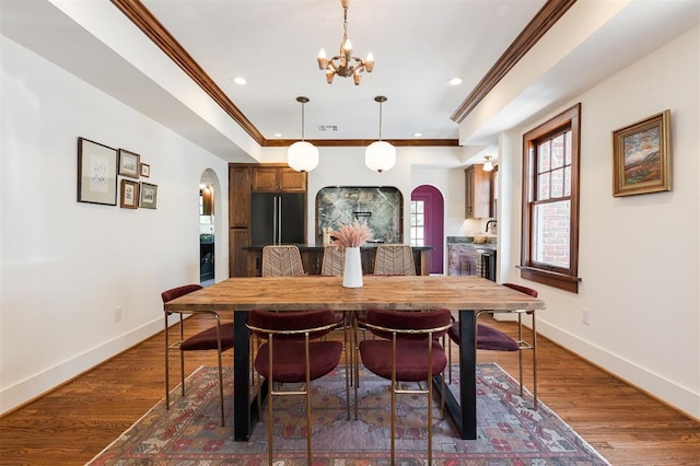 814 NE 18th St, Oklahoma City, OK 73105 - dining space with arched walkways, ornamental molding, a chandelier, recessed lighting, and dark wood-style floors