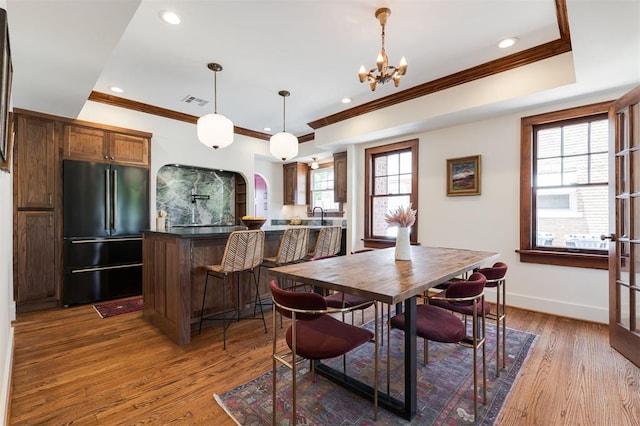 814 NE 18th St, Oklahoma City, OK 73105 - dining space featuring ornamental molding, dark wood-style flooring, a chandelier, recessed lighting, and arched walkways