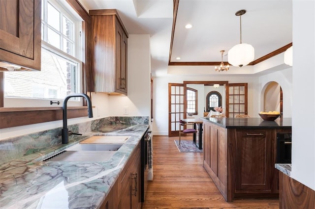 814 NE 18th St, Oklahoma City, OK 73105 - kitchen featuring wood finished floors, hanging light fixtures, a chandelier, recessed lighting, and dishwasher