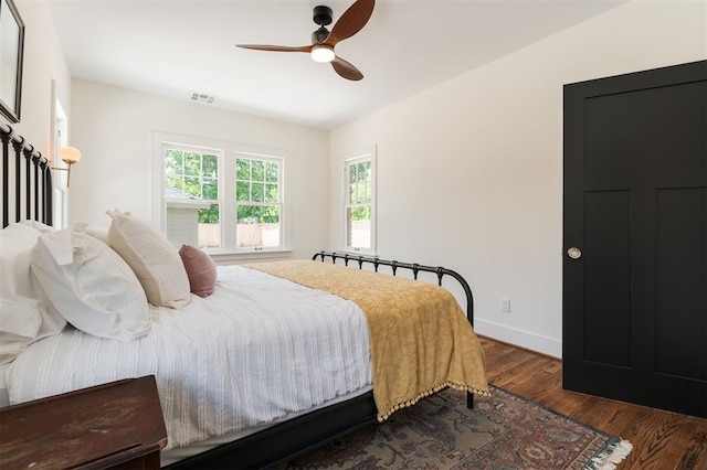 814 NE 18th St, Oklahoma City, OK 73105 - bedroom with dark wood-style floors, multiple windows, and ceiling fan