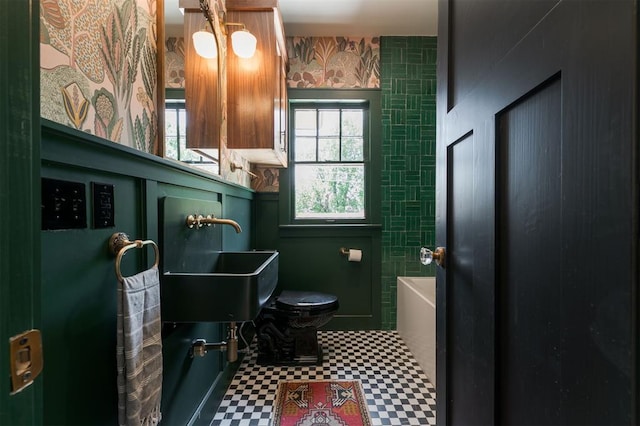 814 NE 18th St, Oklahoma City, OK 73105 - full bath with tile patterned floors and a tub to relax in