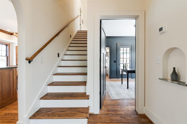 814 NE 18th St, Oklahoma City, OK 73105 - stairs featuring wood finished floors, healthy amount of natural light, and arched walkways