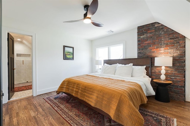 814 NE 18th St, Oklahoma City, OK 73105 - bedroom featuring wood finished floors, vaulted ceiling, a ceiling fan, and ensuite bath