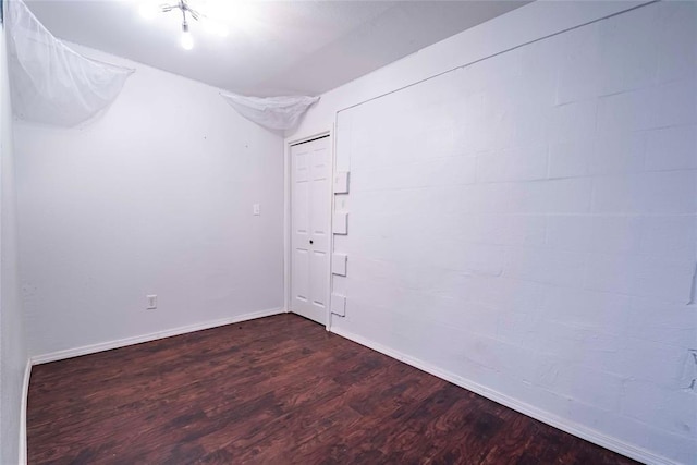 201 E 2nd St, Stroud, OK 74079 - empty room featuring dark wood-style floors and baseboards
