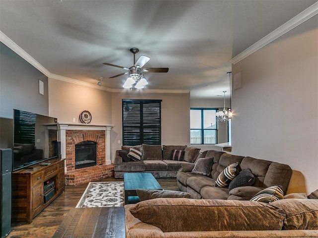 2724 SE 97th St, Oklahoma City, OK 73160 - living room with dark wood-style flooring, a ceiling fan, crown molding, a fireplace, and a chandelier