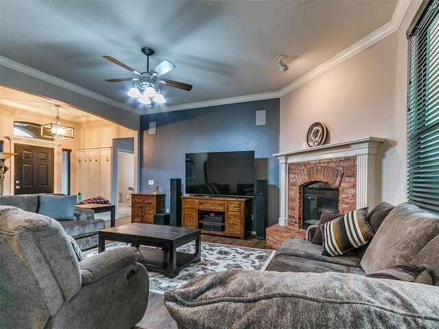 2724 SE 97th St, Oklahoma City, OK 73160 - living room featuring wood finished floors, a ceiling fan, crown molding, and a brick fireplace