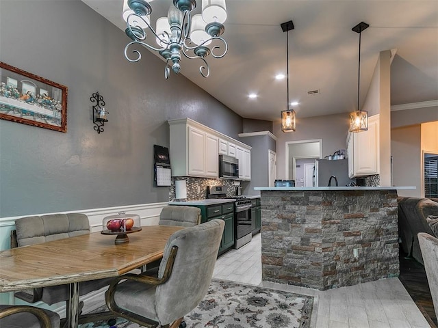 2724 SE 97th St, Oklahoma City, OK 73160 - dining space featuring a chandelier, light wood-type flooring, and wainscoting