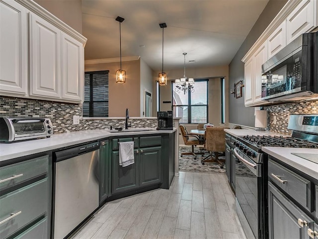 2724 SE 97th St, Oklahoma City, OK 73160 - kitchen featuring stainless steel appliances, a chandelier, white cabinets, light wood-type flooring, and backsplash