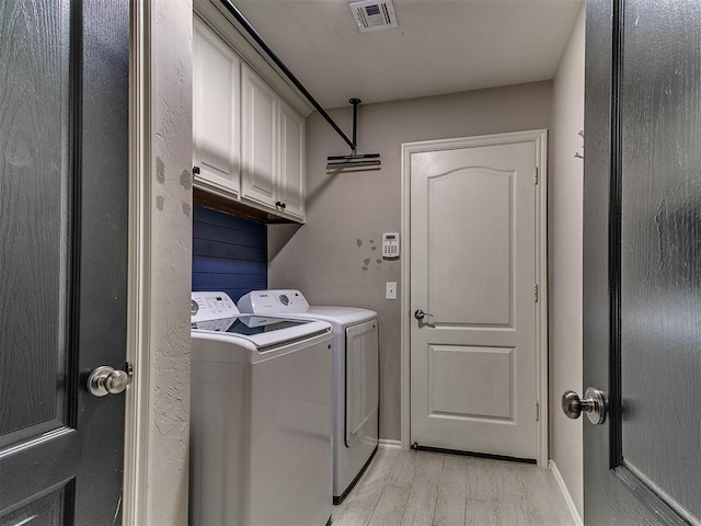 2724 SE 97th St, Oklahoma City, OK 73160 - washroom with washer and clothes dryer, cabinet space, and light wood-type flooring