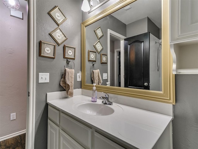 2724 SE 97th St, Oklahoma City, OK 73160 - bathroom featuring vanity, wood finished floors, and a textured wall