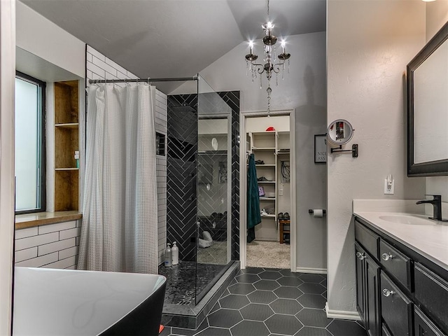 2724 SE 97th St, Oklahoma City, OK 73160 - bathroom featuring a stall shower, lofted ceiling, vanity, a walk in closet, and a chandelier