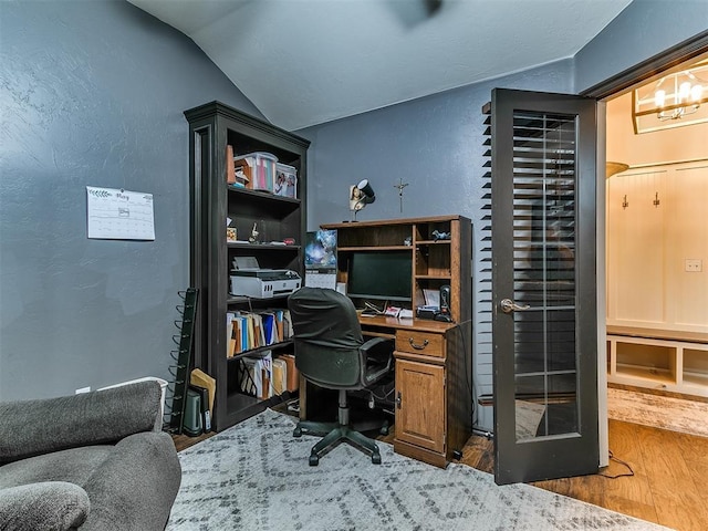 2724 SE 97th St, Oklahoma City, OK 73160 - office with wood finished floors, a textured wall, vaulted ceiling, and a chandelier