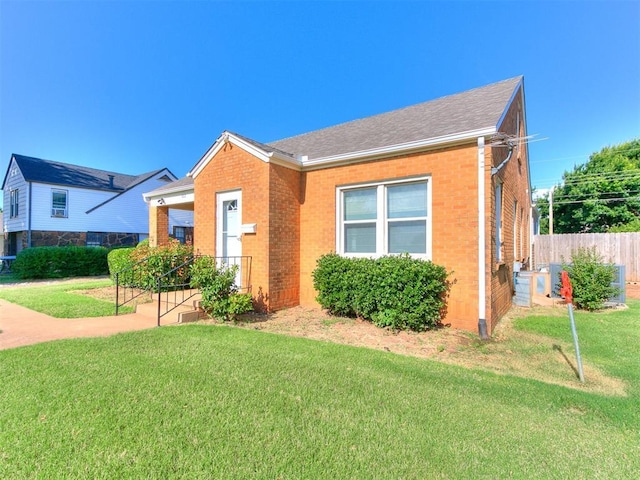 1012 S 8th St, Kingfisher, OK 73750 - view of front of house featuring brick siding and roof with shingles