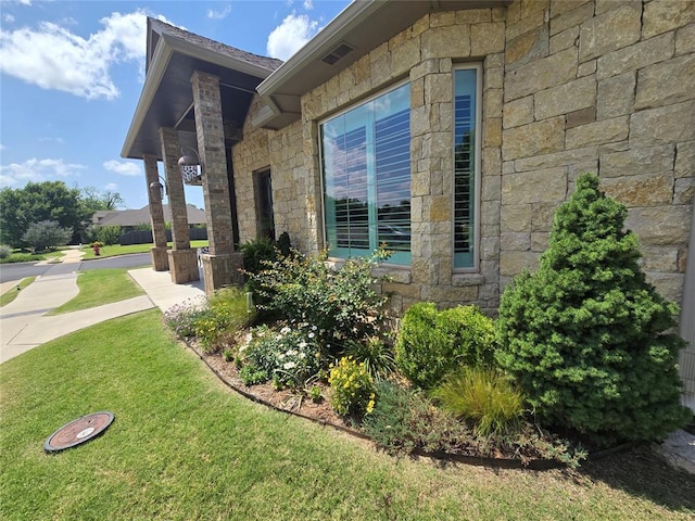 9252 Elaine Dr, Midwest City, OK 73130 - view of home's exterior featuring stone siding and a yard